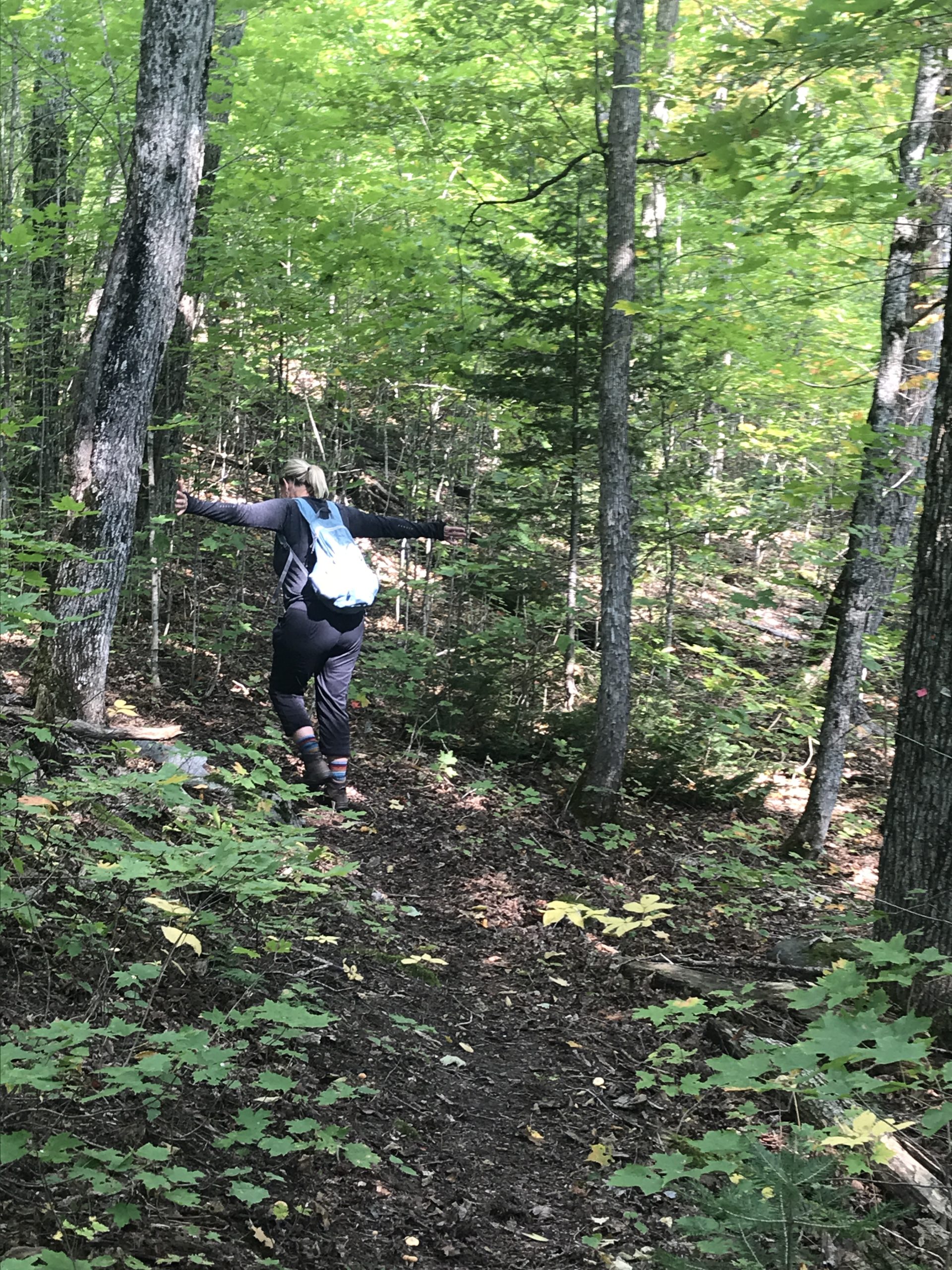 “Woman walking with arms outstretched in Algonquin Park, Ontario.”